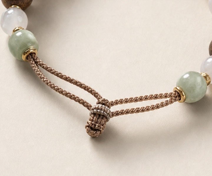 Beads stop; two cords carry the outline on · design image
