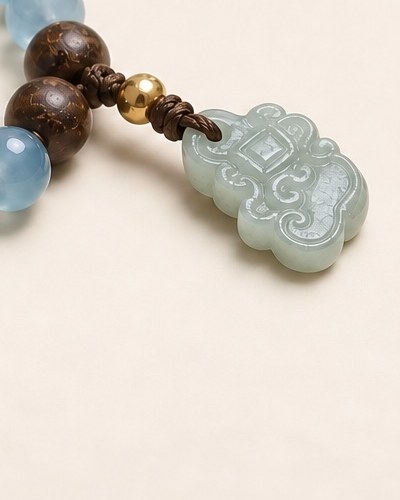 A carved piece where the wood beads meet